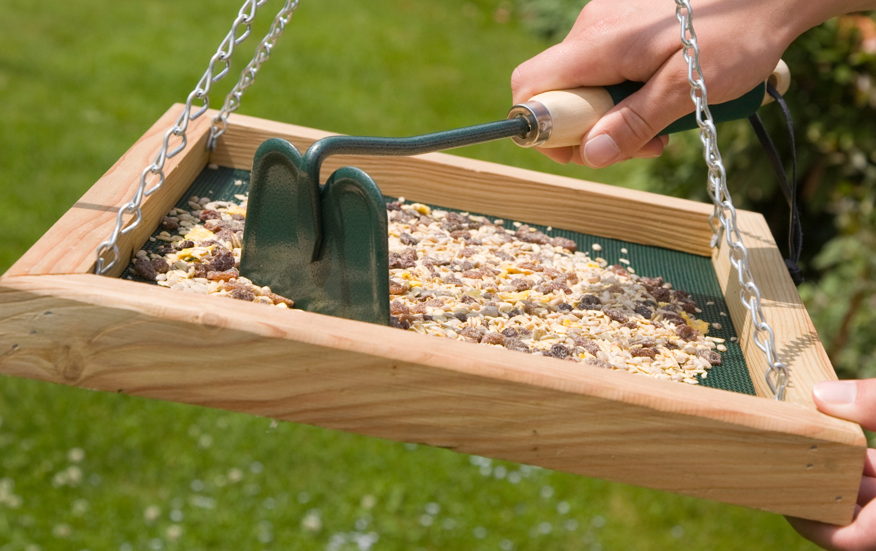 Child smiles while presenting the assembled nest box building kit
