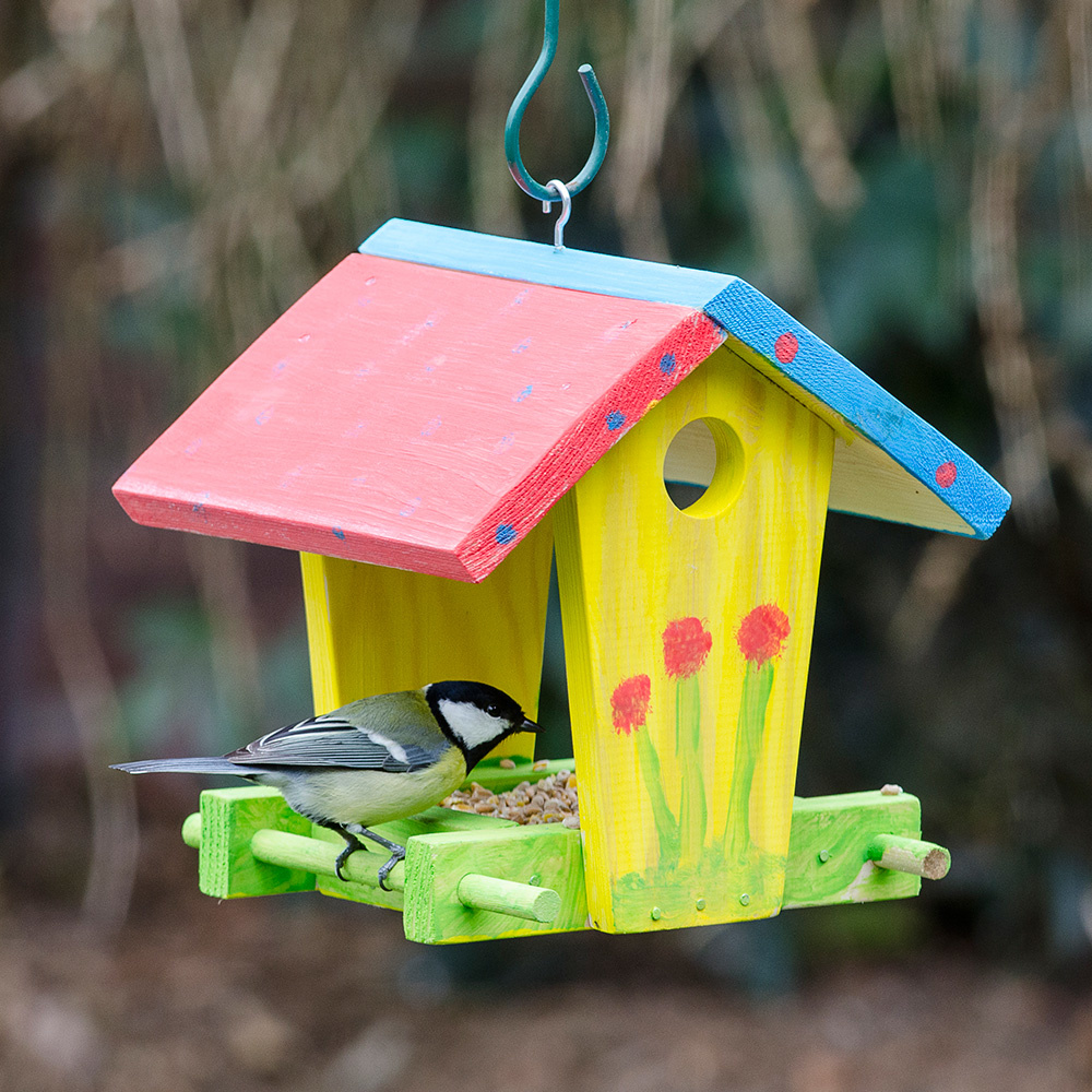 A colorfully painted bird house.